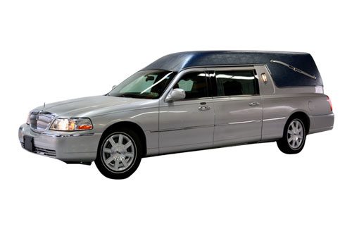 Silver hearse with tinted windows and classic design.