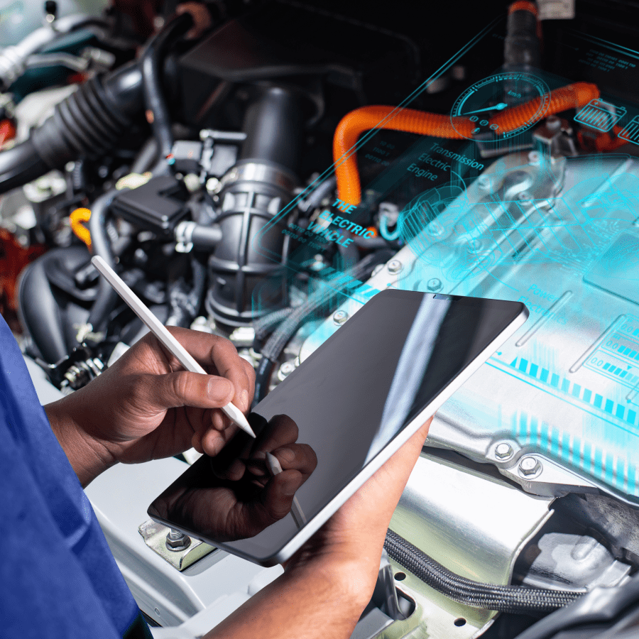 Technician using a tablet to diagnose a car engine.
