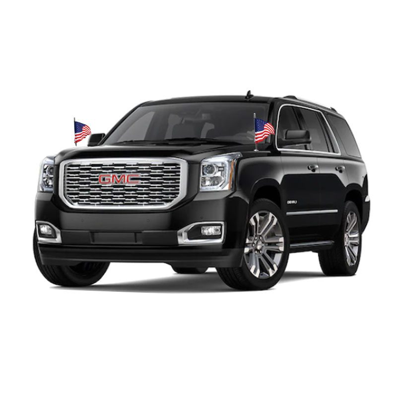 A black GMC SUV with small American flags on the front.