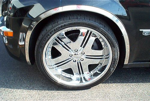 Close-up of a shiny chrome wheel on a black car.