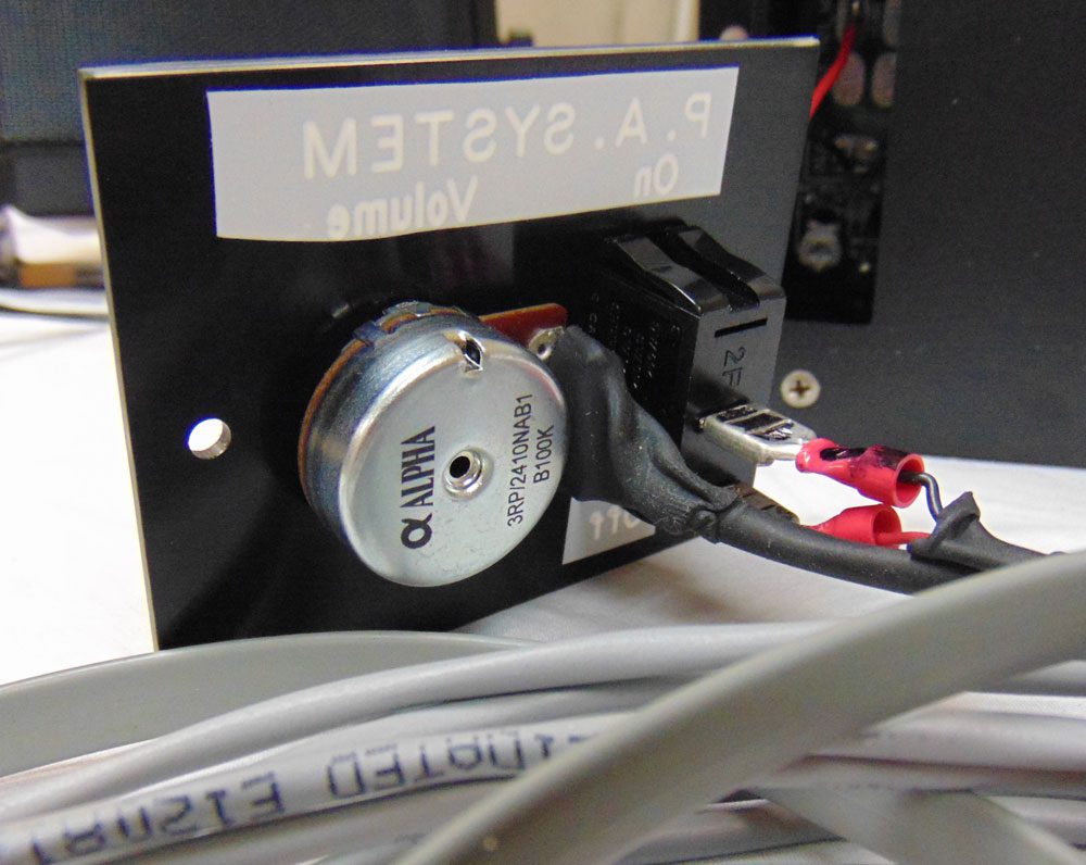Close-up of a computer cooling fan with cables attached.