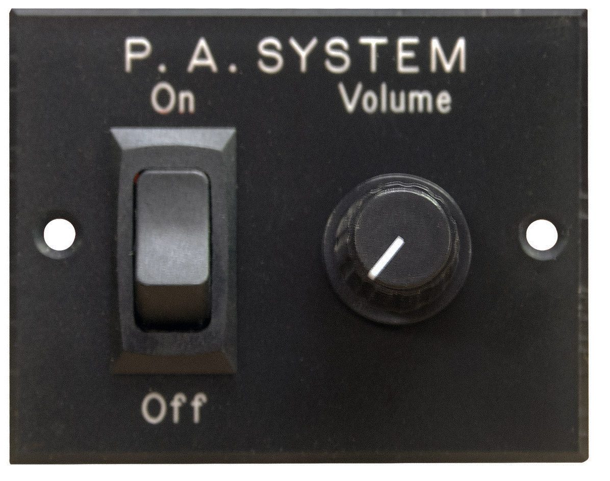 Close-up of a P.A. system switch and volume knob on an electronic device.