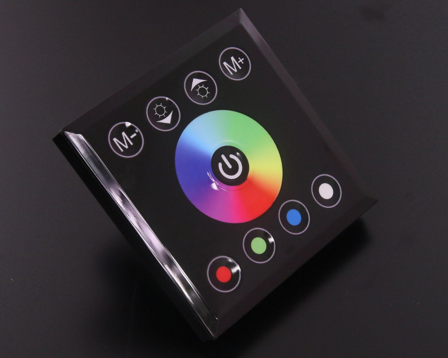 A sleek LED color controller with touch-sensitive buttons and a color wheel.