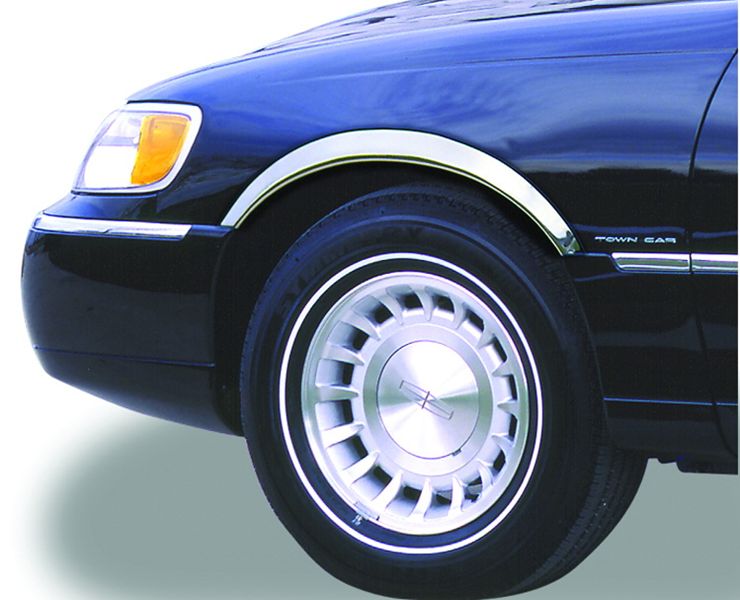 Close-up of a car's front wheel and fender with 'Town Car' badge.