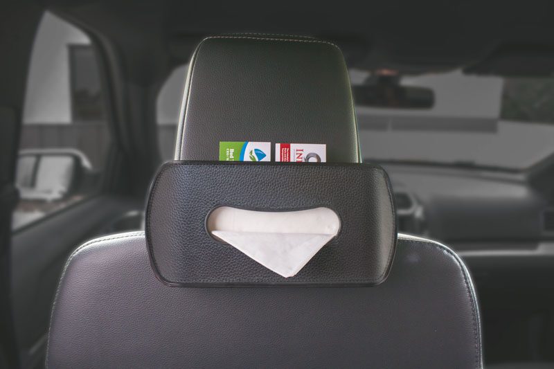 Car seat back organizer holding tissues and cards.